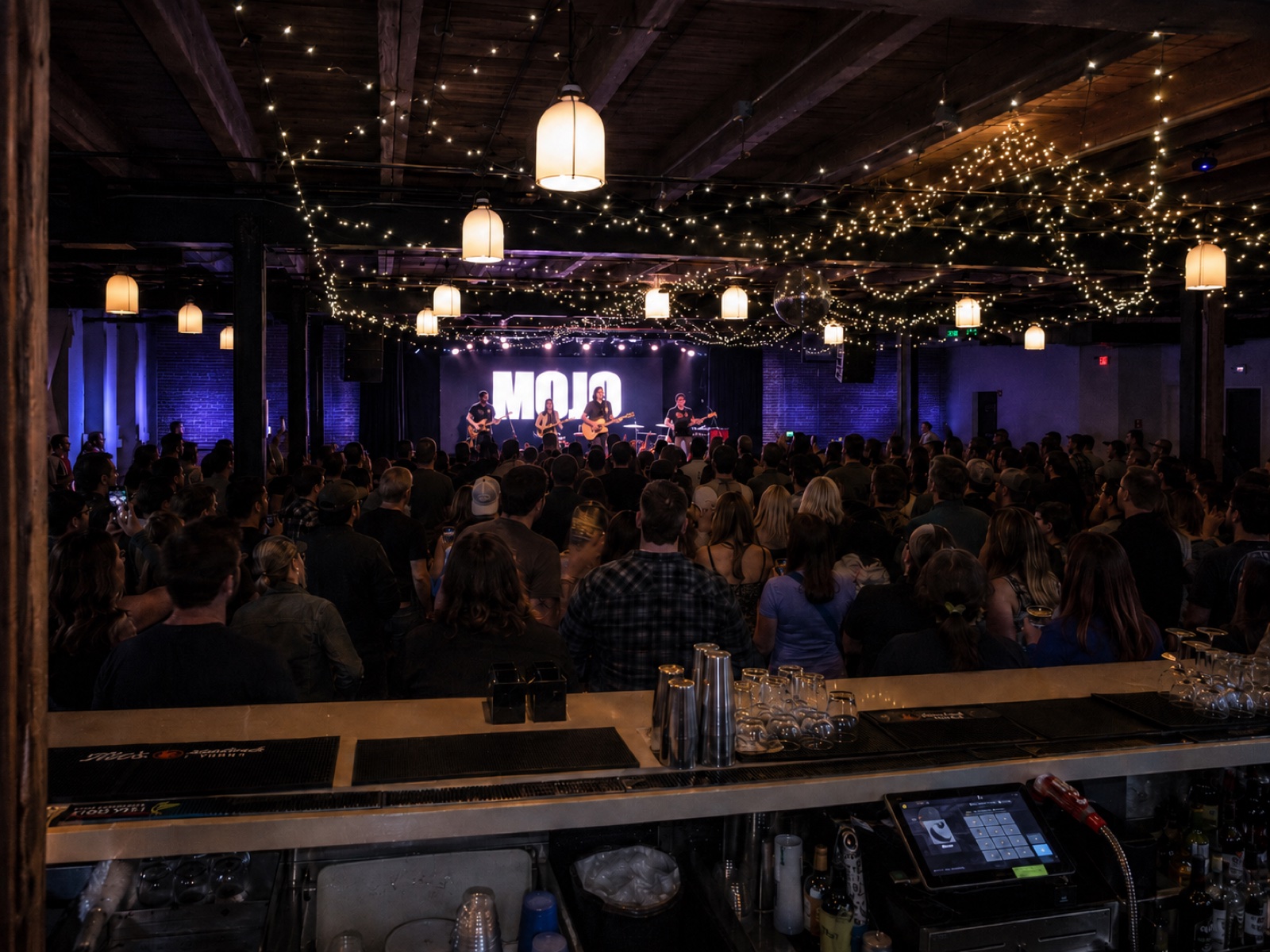 The Social — MOJO concert with packed crowd under string lights